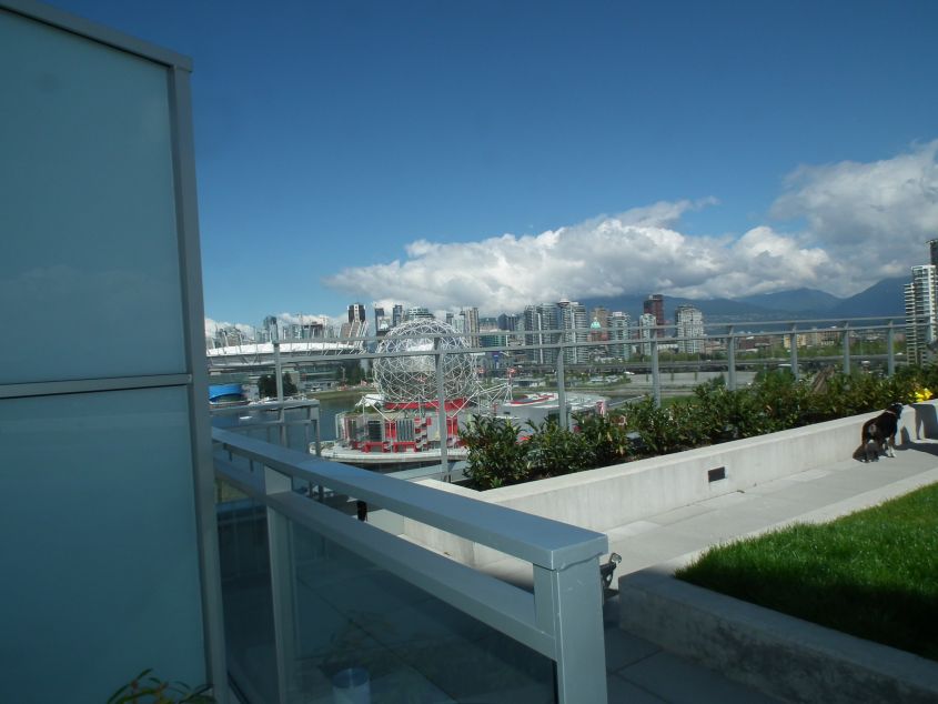1 Bedroom + Den pet friendly condo in the heart of Olympic Village with huge patio and views of water and mountains!